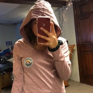 A pink long sleeve shirt with a hood